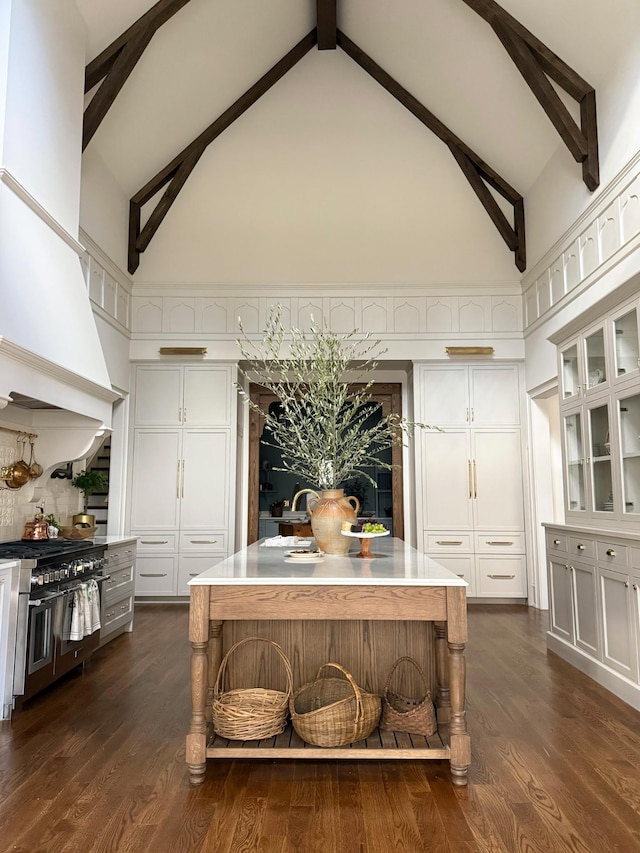 391 The Lady Of The Lake Ln, Franklin, TN 37067 - detailed view of range with two ovens, white cabinets, beamed ceiling, glass insert cabinets, and dark wood-style flooring