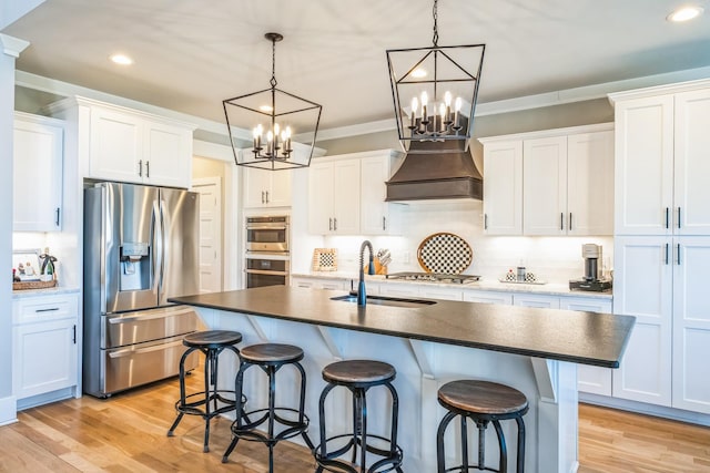 kitchen featuring ornamental molding, stainless steel appliances, light wood-style floors, premium range hood, and a kitchen bar