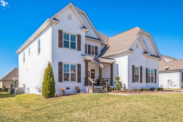 traditional-style home featuring crawl space, a front lawn, board and batten siding, and brick siding