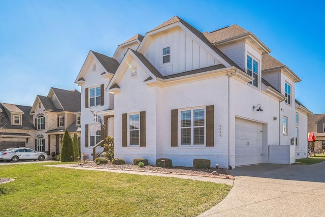 view of front of house featuring a garage, concrete driveway, a front lawn, board and batten siding, and brick siding