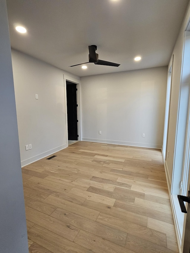 empty room featuring recessed lighting, visible vents, a ceiling fan, light wood-type flooring, and baseboards