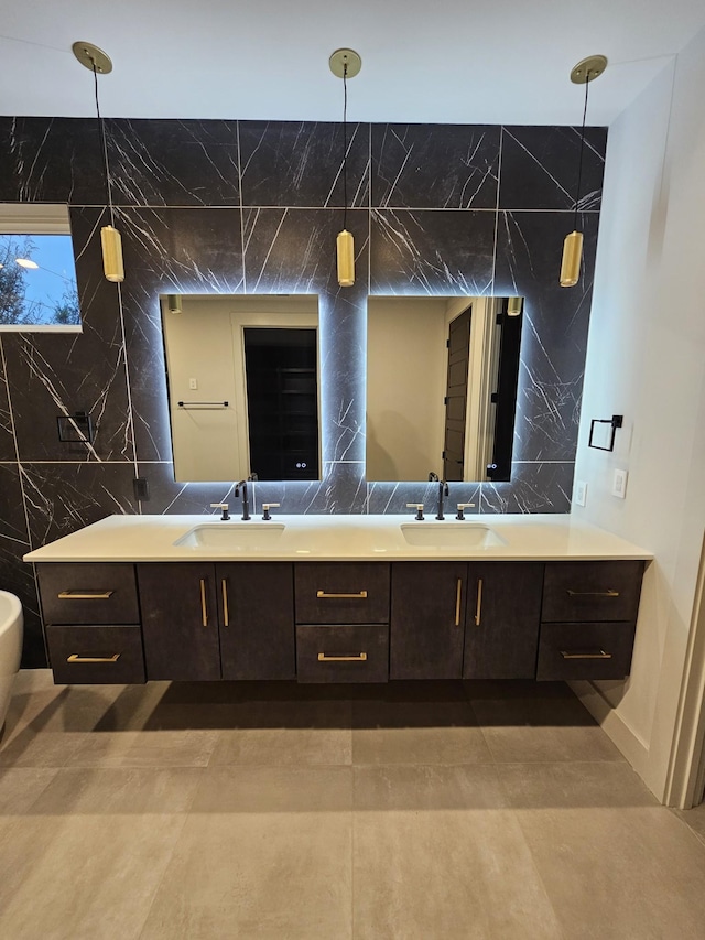 full bathroom with double vanity, tasteful backsplash, and a sink