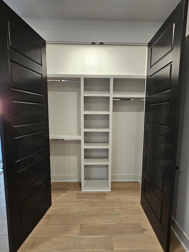 spacious closet with light wood finished floors