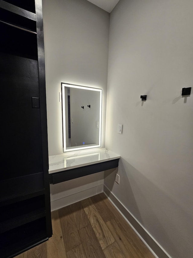 interior space with wood finished floors and baseboards