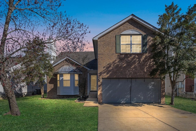 traditional-style house with concrete driveway, brick siding, an attached garage, and a front lawn