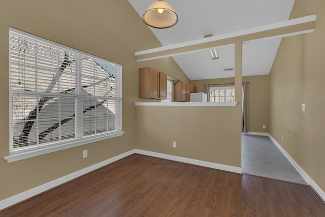 unfurnished living room with dark wood finished floors, visible vents, vaulted ceiling, and baseboards