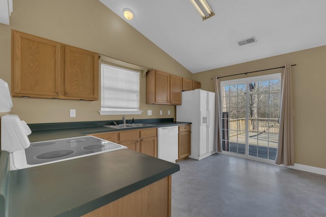 kitchen with lofted ceiling, white appliances, a sink, visible vents, and dark countertops