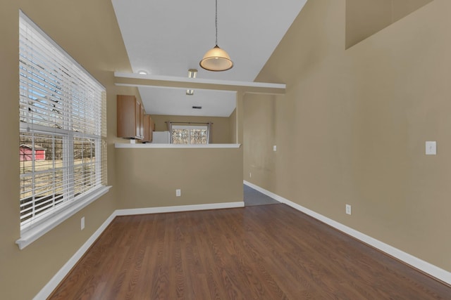 unfurnished living room with baseboards and wood finished floors