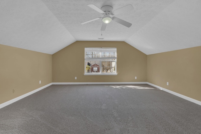 bonus room with a textured ceiling, ceiling fan, vaulted ceiling, and baseboards