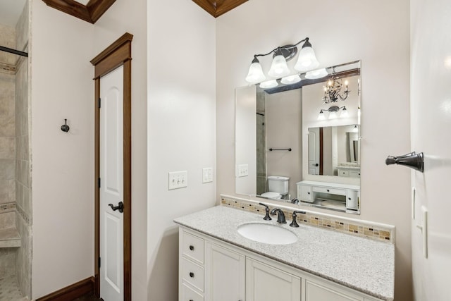 full bathroom featuring tiled shower, vanity, and toilet