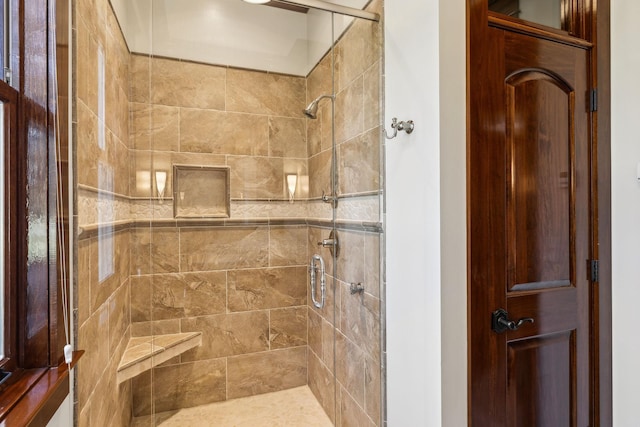 bathroom with tiled shower