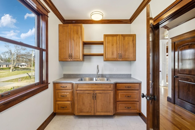 kitchen with crown molding, brown cabinets, a sink, and open shelves