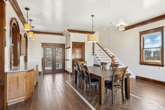 dining room with stairs, plenty of natural light, and wood tiled floor