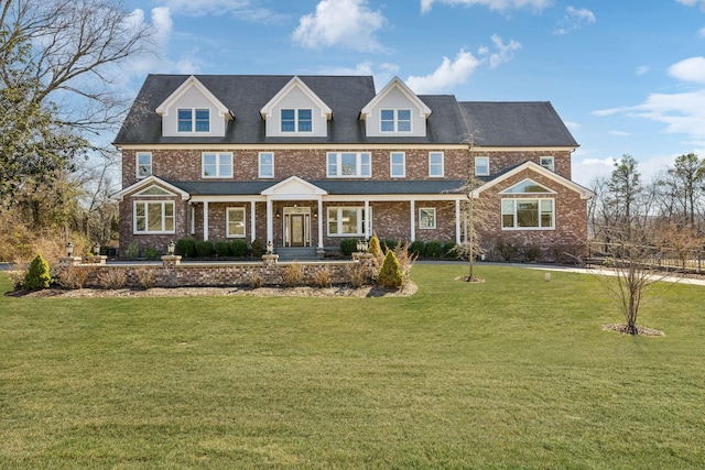 view of front of home featuring brick siding and a front lawn