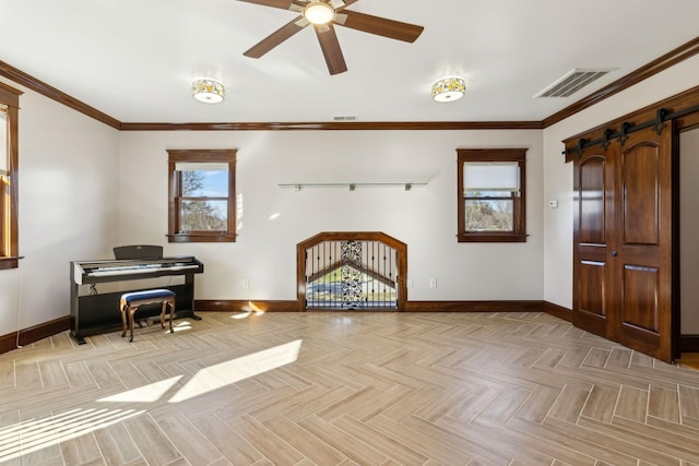 foyer entrance with ornamental molding, visible vents, baseboards, and a barn door