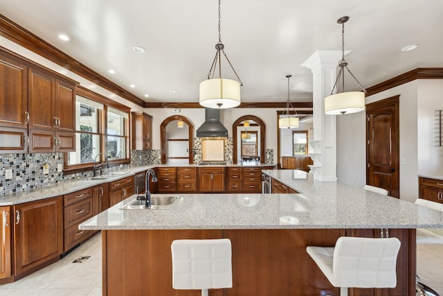 kitchen with a breakfast bar area, backsplash, and a sink