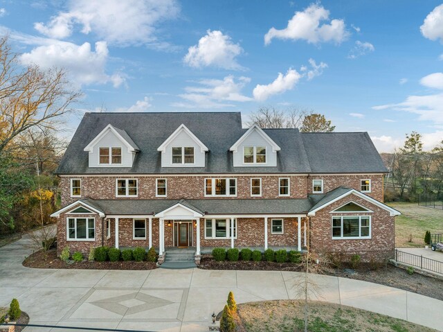 view of front facade with fence and brick siding