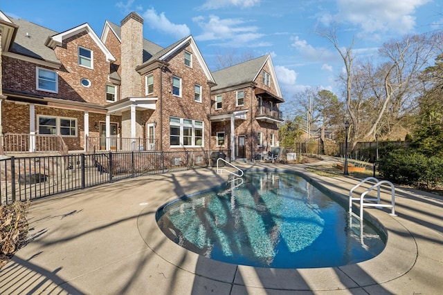 view of pool featuring a fenced in pool, fence, and a patio