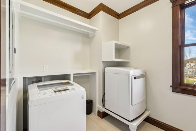 washroom featuring a wealth of natural light, laundry area, and washing machine and clothes dryer