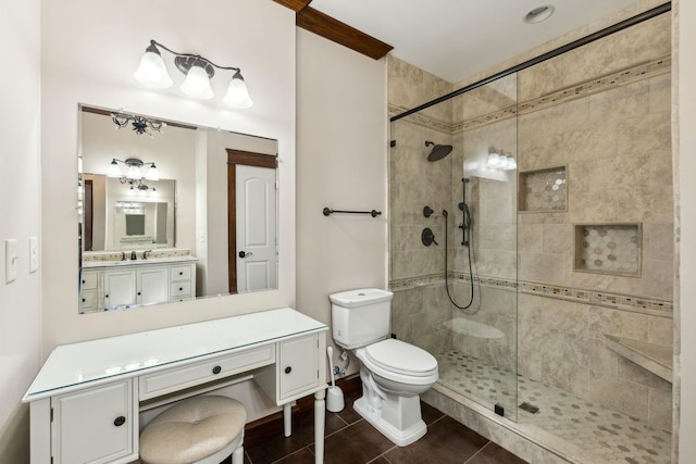 full bath featuring tile patterned flooring, a tile shower, vanity, and toilet