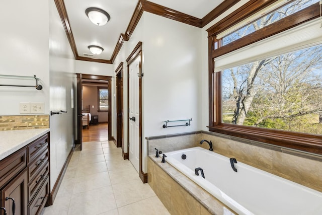 bathroom featuring tile patterned flooring, visible vents, vanity, ornamental molding, and a bath