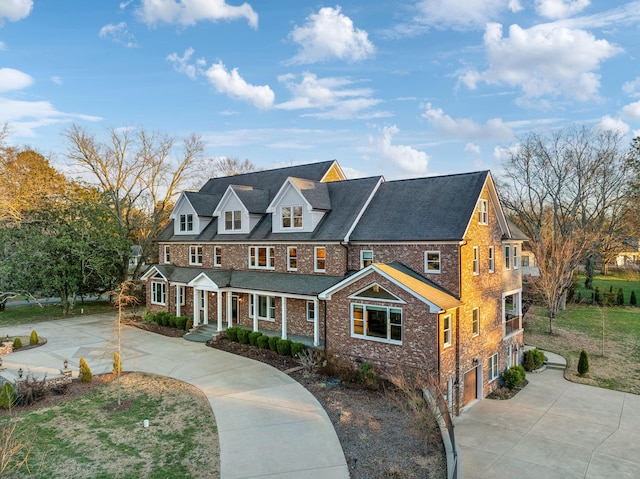 view of front of property with driveway and brick siding