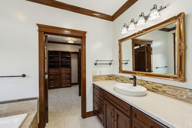 full bathroom with crown molding, a spacious closet, backsplash, a bathing tub, and vanity