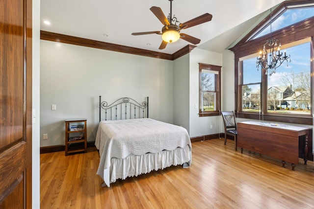 bedroom featuring crown molding, ceiling fan with notable chandelier, wood finished floors, and baseboards