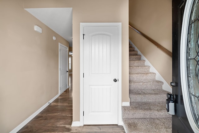 stairway with baseboards and wood finished floors