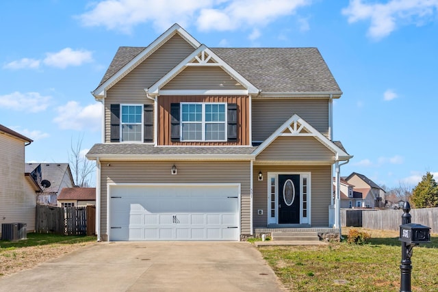 view of front of house with a garage, cooling unit, fence, and driveway