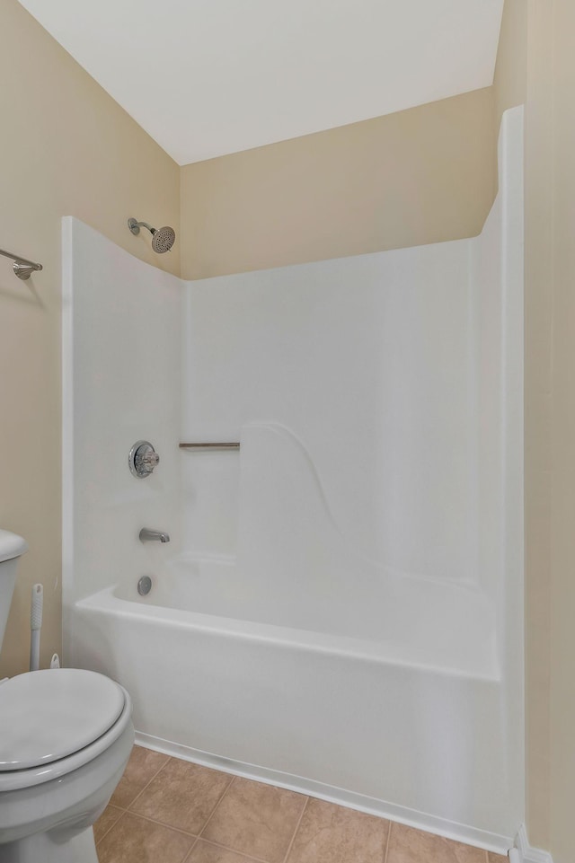 full bathroom featuring shower / bathtub combination, toilet, and tile patterned floors