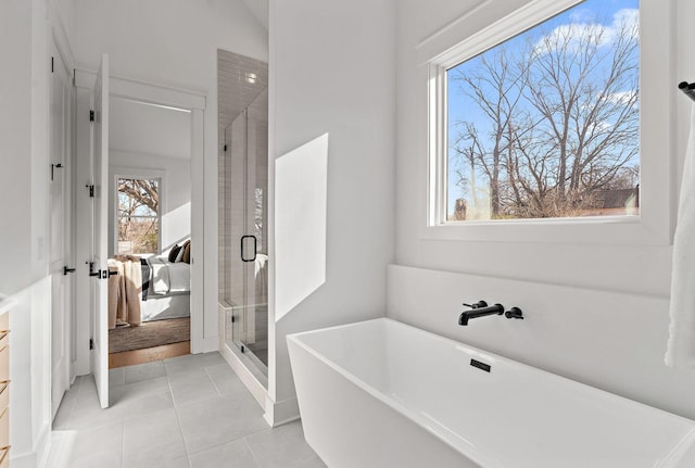 ensuite bathroom featuring french doors, a soaking tub, a stall shower, connected bathroom, and tile patterned flooring