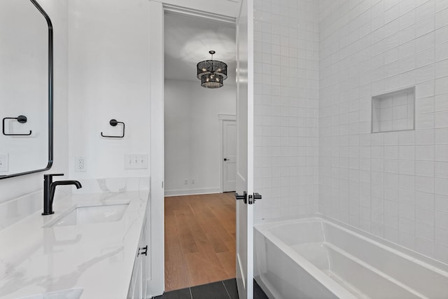 full bathroom featuring vanity, baseboards, shower / washtub combination, tile patterned floors, and an inviting chandelier