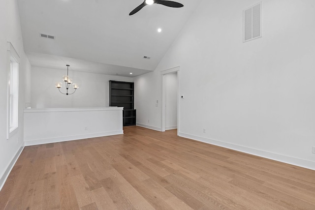 unfurnished living room with baseboards, visible vents, light wood finished floors, and ceiling fan with notable chandelier