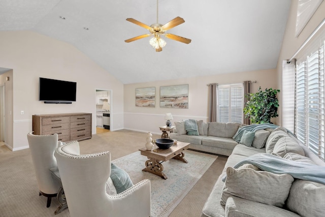 living room with a healthy amount of sunlight, ceiling fan, and light colored carpet