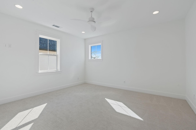 unfurnished room with recessed lighting, baseboards, and light colored carpet