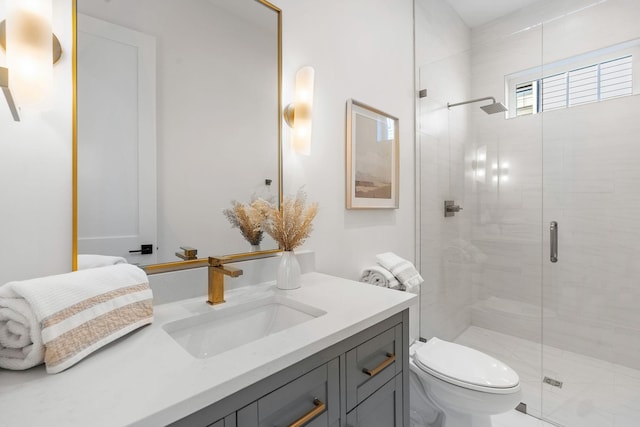 bathroom featuring a stall shower, vanity, and toilet