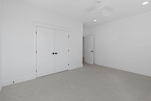 unfurnished bedroom featuring baseboards, recessed lighting, and light colored carpet