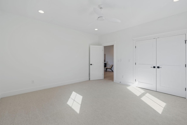 unfurnished bedroom featuring light carpet, ceiling fan, recessed lighting, and baseboards