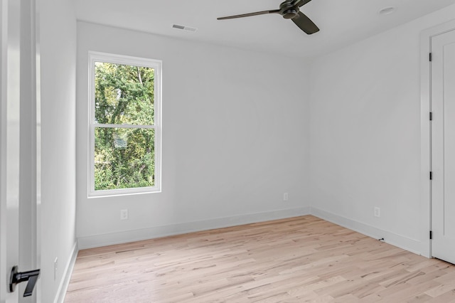 unfurnished room with light wood-style floors, baseboards, visible vents, and a ceiling fan