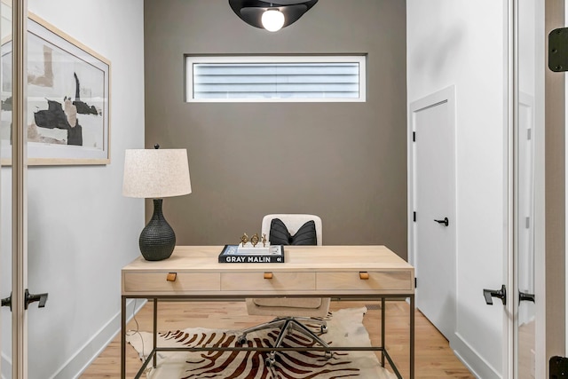 office area featuring light wood-type flooring, french doors, and baseboards