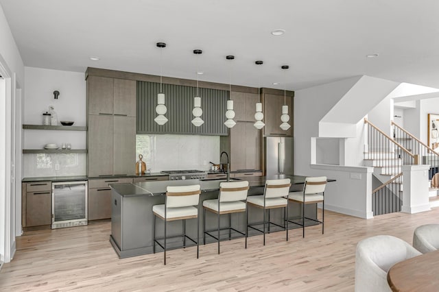 kitchen featuring a breakfast bar, wine cooler, open shelves, dark countertops, and high end refrigerator