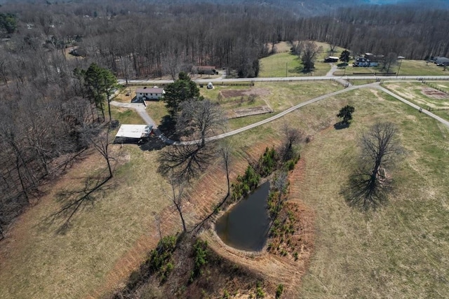 birds eye view of property with a rural view and a wooded view