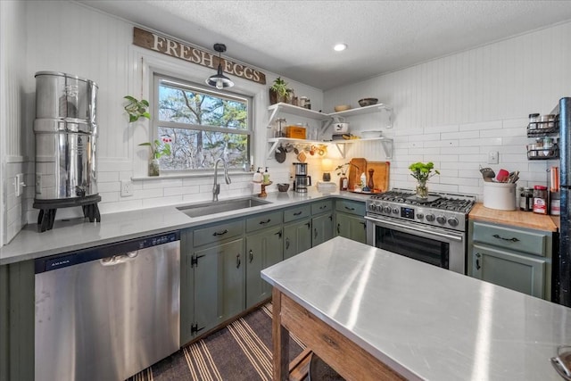 kitchen with a sink, stainless steel countertops, backsplash, and stainless steel appliances