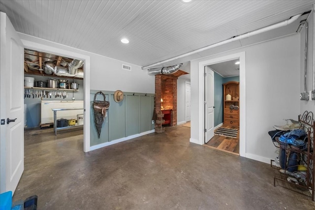 interior space with visible vents, baseboards, and finished concrete flooring