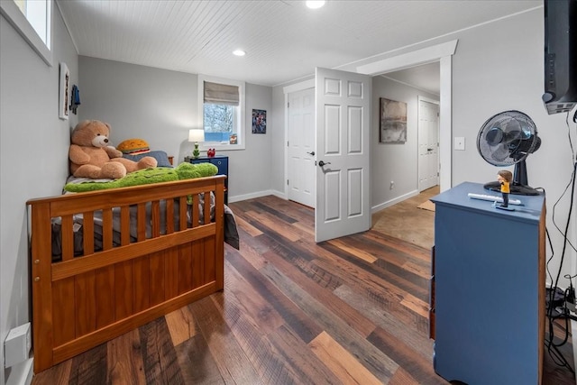 bedroom with dark wood-type flooring and baseboards