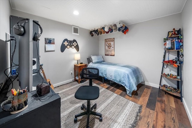 bedroom featuring wood finished floors and baseboards