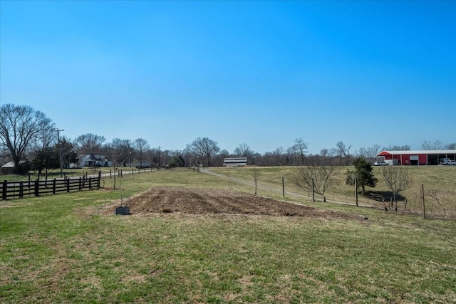 view of yard with a rural view and fence