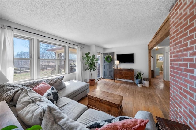 living area with hardwood / wood-style flooring and a textured ceiling