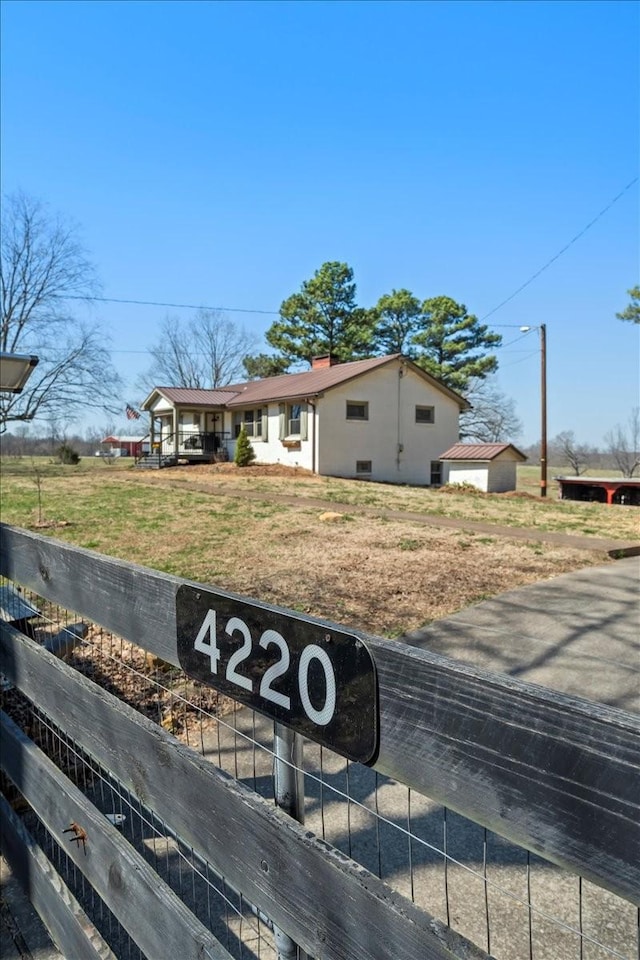 view of front of home with crawl space, a chimney, and a front yard